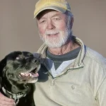 Photographer Trevor Samson photographing a dog and owner during a pet portrait session.