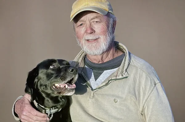 Photographer Trevor Samson photographing a dog and owner during a pet portrait session.