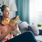 Person listening to podcasts through headphones.