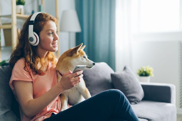 Person listening to podcasts through headphones.