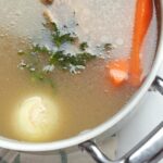 Homemade bone broth for dogs made with beef bones, carrots and celery