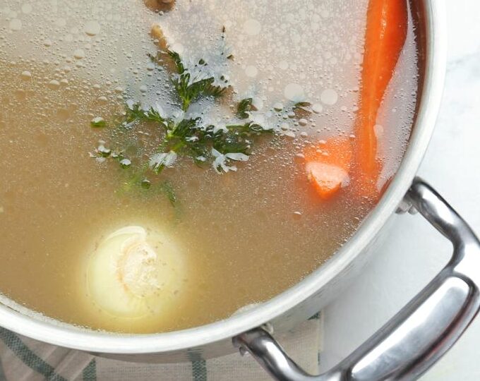 Homemade bone broth for dogs made with beef bones, carrots and celery