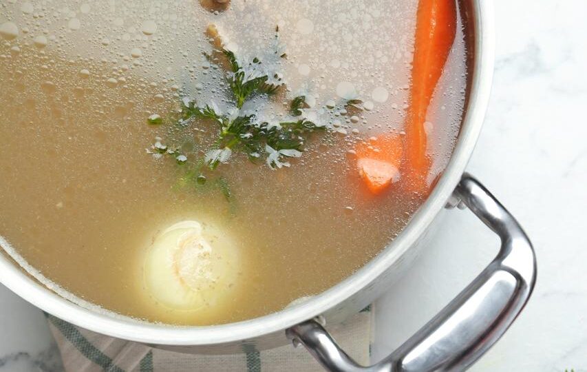Homemade bone broth for dogs made with beef bones, carrots and celery